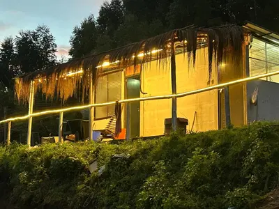 a train car is covered in rust with lights on it at Mystic Valley Vattavada in Vattavada