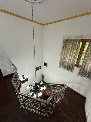 a room with a chandelier hanging from the ceiling at Villa Tharavadu in Angamali