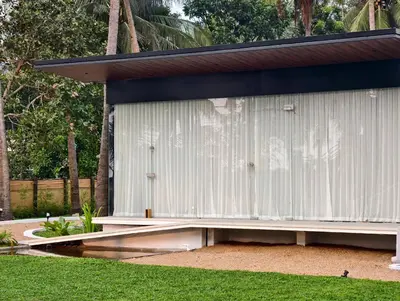 a white shed sitting on top of a yard at Reflections by SOL Escapes near Cherai Beach in Pallipuram