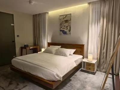 a bedroom with a large bed with white sheets and pillows at Reflections by SOL Escapes near Cherai Beach in Pallipuram