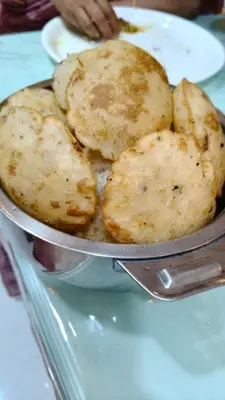 a pan filled with food on top of a table at South point homestay in Virajpet