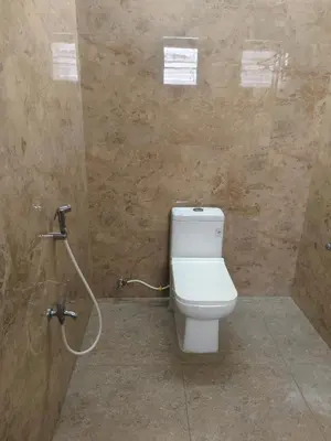 a bathroom with a toilet and a shower at Goldwins Grand A comfort stay in Coimbatore