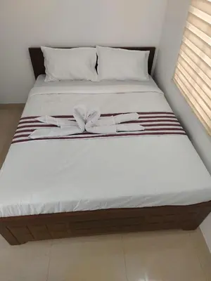 a bed with a bow on top of it at Goldwins Grand A comfort stay in Coimbatore