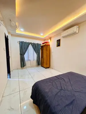 a bedroom with a bed and a window with curtains at Wild Bliss in Sultan Bathery
