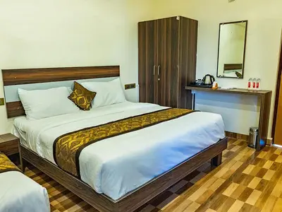 a bedroom with a large bed and a mirror at New SK Residency Mysore in Mysore