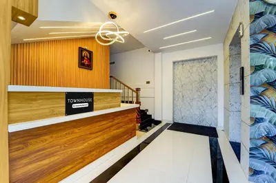 a lobby with a door and a staircase at Super Townhouse Cochin Airport Formerly Skyluxe in Cochin