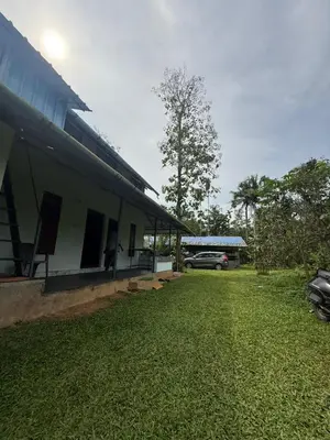 a building with a car parked next to it at Nanavu Farmhouse in Māla