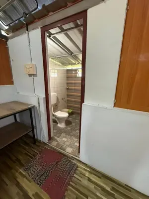 a bathroom with a toilet in a room at Nanavu Farmhouse in Māla