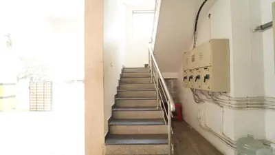 a staircase in a building with boxes on the wall at Union Rooms in Coimbatore