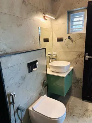 a bathroom with a toilet and a sink at ThunderHill by Casablanca - A Premium Pool Villa in Meenangadi