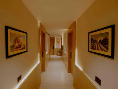 a hallway with two paintings on the walls and a hallway with a hallway at Nine, Boutique hotel with luxury room stay, mysore in Mysore
