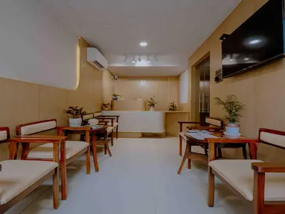 a waiting room with tables and chairs in a hospital at Nine, Boutique hotel with luxury room stay, mysore in Mysore