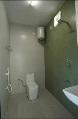 a bathroom with a toilet and a sink at Keerthana Marriage hall and Rooms in Coimbatore