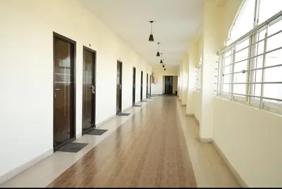 an empty hallway of a building with doors and windows at Keerthana Marriage hall and Rooms in Coimbatore