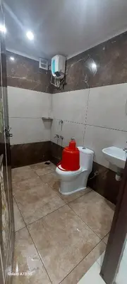 a bathroom with a red toilet and a sink at Hill valley farm resort in Viripara