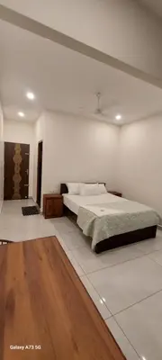 a bedroom with a large bed in a room at Hill valley farm resort in Viripara