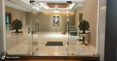 a glass case in a room with two beds in it at Vanaalayam Retreat Palladam By Arcadia in Palladam