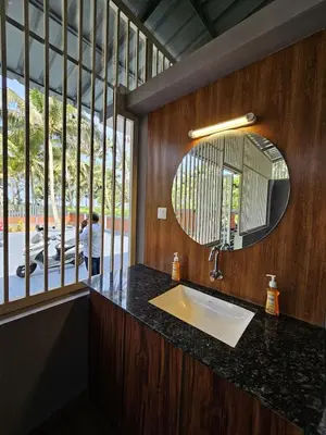 a bathroom with a sink and a mirror at Dream nest beach house Resort with private beach entrance in Trichūr