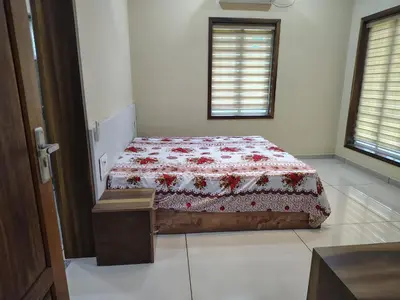 a bedroom with a bed with a red and white quilt at Oriyon villa in Kāladi