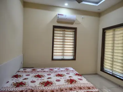 a bedroom with a bed with red flowers on it at Oriyon villa in Kāladi