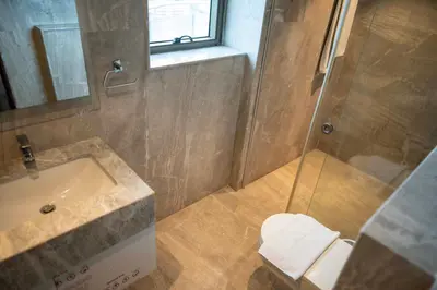 a bathroom with a shower and a sink and a toilet at MARINE DRIVE - BEACH FRONT LUXURY PENTHOUSE by NIOTEL in Kozhikode