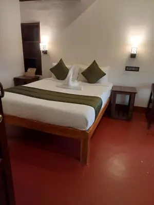 a bedroom with a large bed in a room at Coorg Mystere Luxury Home Stay in Madikeri