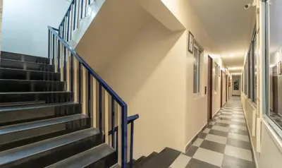 a hallway with stairs and a checkered floor at Itsy Hotels Everest Leela Residency in Erode