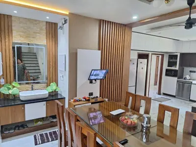 a kitchen and dining room with a glass table at Dreams Premium Villa in Kozhikode