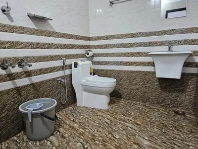 a bathroom with a toilet and a sink at Guruvayur Nest Homestay in Guruvāyūr