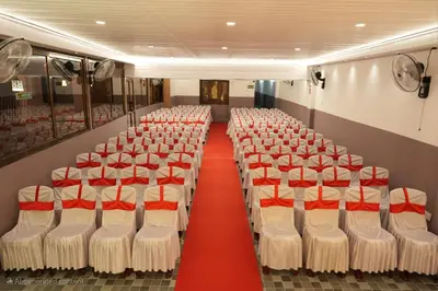 a room with rows of chairs with red seats at Guruvayur Nest Homestay in Guruvāyūr
