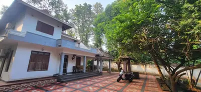a scooter parked in front of a house at Periyar Heritage in Kotamangalam