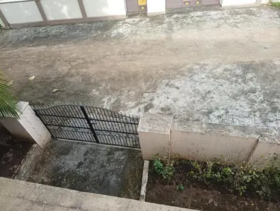 an empty parking lot with a metal fence at Shield Guest Accommodation in Pudunagaram