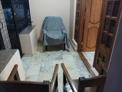 a view of a hallway with a table on the floor at Shield Guest Accommodation in Pudunagaram