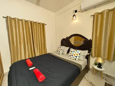 a bedroom with a bed with red pillows on it at Casa de Shalom - 3 Bedroom AC Villa 65