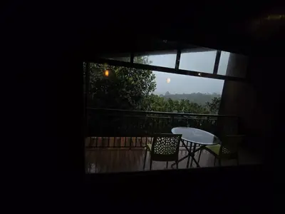 a view of a balcony with a table and chairs at Woodshade resort in Wayanad