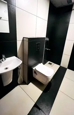 a bathroom with a toilet and a sink at Woodshade resort in Wayanad