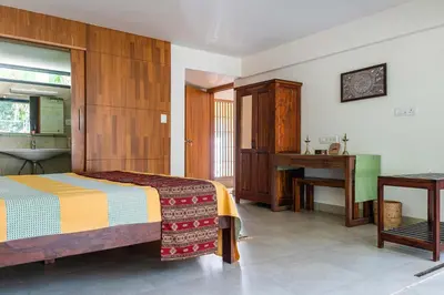 a bedroom with a bed and a sink and a desk at Spacious 3BR Daveys Townhouse with Private Lawn Pet Friendly and Complimentary Breakfast in Mysore
