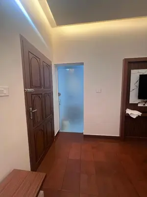 a living room with a door and a television at Haveninn in Kallana