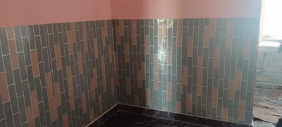 a bathroom with a shower with brown tiles at Sona rooms in Coimbatore