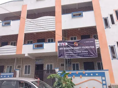 a building with a sign in front of it at Sona rooms in Coimbatore