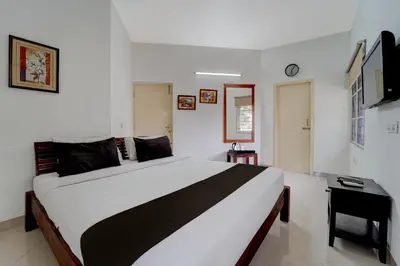 a bedroom with a large bed in a room at Palette Nirvana Signature Apartment by CheckIn, Coimbatore in Coimbatore