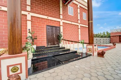 a red brick building with stairs and a door at Palette Peace Village by CheckIn | Garden | Breakfast | Erode in Erode