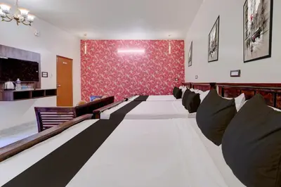 a room with a row of couches in the middle at Palette Peace Village by CheckIn | Garden | Breakfast | Erode in Erode