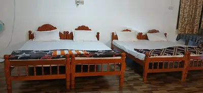 two beds sitting next to each other in a room at BeingWild Resort in Masinagudi