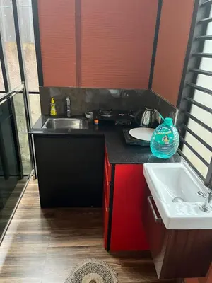 a kitchen with a sink and a counter top at Apricot Cottage in Kozhikode