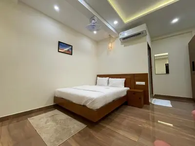 a hotel room with a bed and a air conditioner at The Marina Deluxe Kozhikode - Premium Spacious AC Rooms in Kozhikode