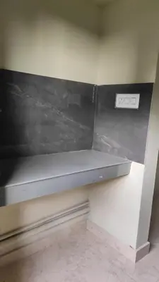 a shelf in a room with a scale on the wall at Green Valley stay in Pattāmbi