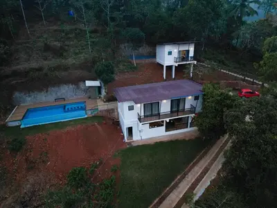 an aerial view of a house with a swimming pool at Camplights Stays in Tariyod