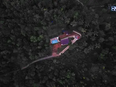 an overhead view of a house in the forest at Camplights Stays in Tariyod