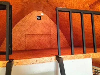 a staircase in a room with orange walls at Bhramaram resort in Kanthalloor